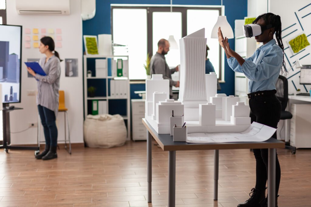 architect standing modern architectural office using virtual reality goggles view 3d plan white foam maquette engineer working with vr headest table with model urban project 3